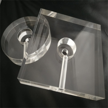 Square and round clear acrylic lamp bases with central mounting rings and wire channels on a dark background