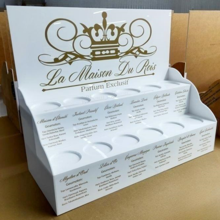 White multi-tier acrylic perfume display stand for La Maison Du Rois with brand crown logo and fragrance notes details